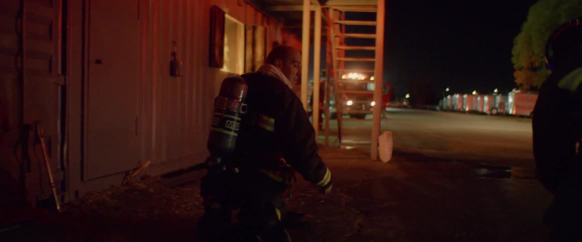 Firefighters prepare hoses to put out a fire