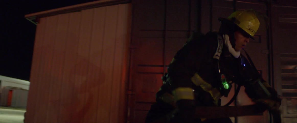 A firefighter pulls on a hose