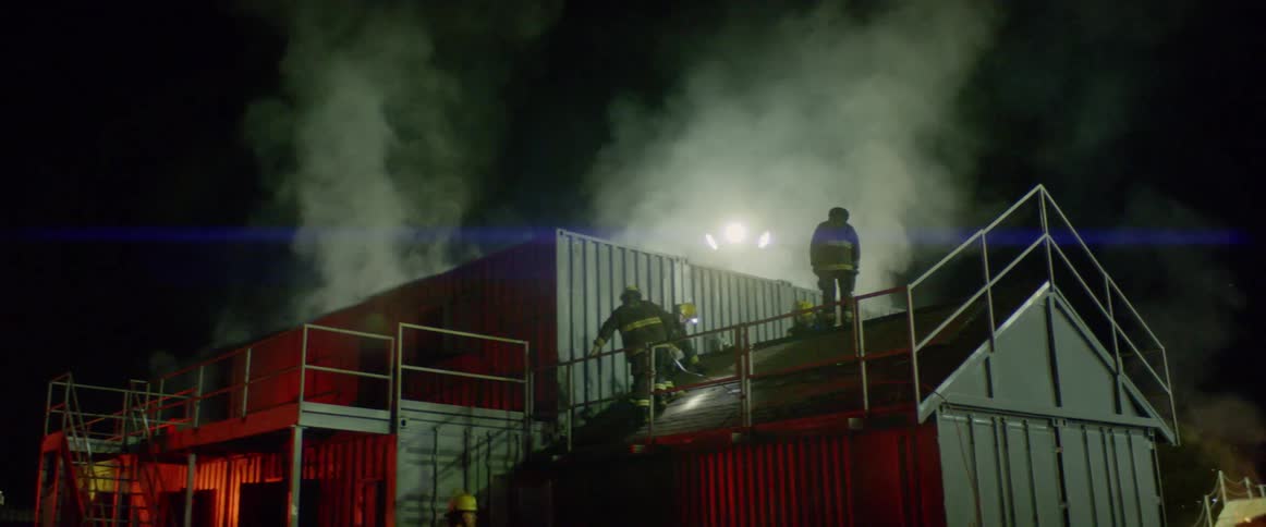 Firefighters work on the scene of accident at night
