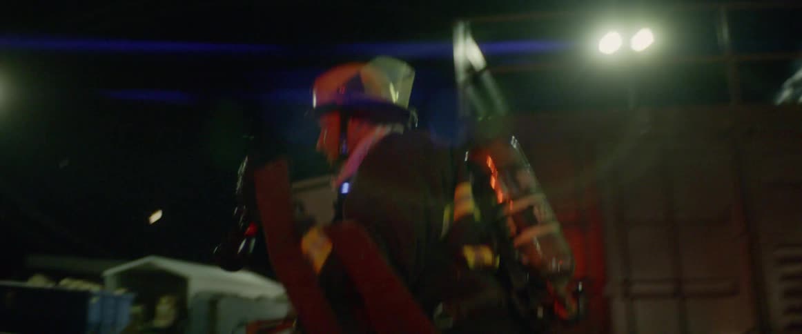 A firefighter runs with a hose