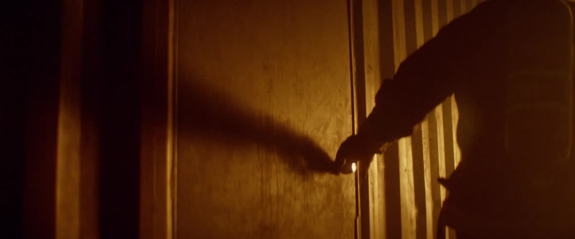 A firefighter closes a metal door