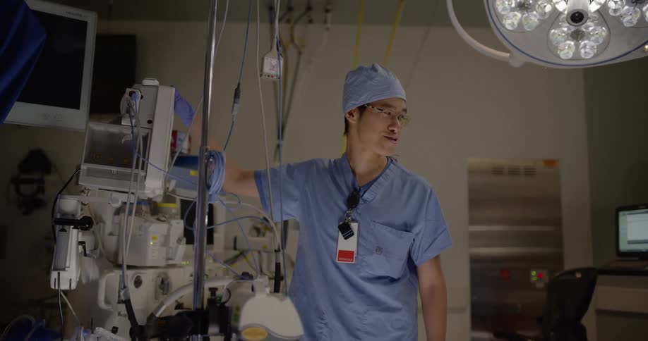 A doctor adjusts a machine