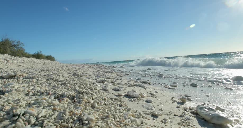 White waves roll up on a rocky beach