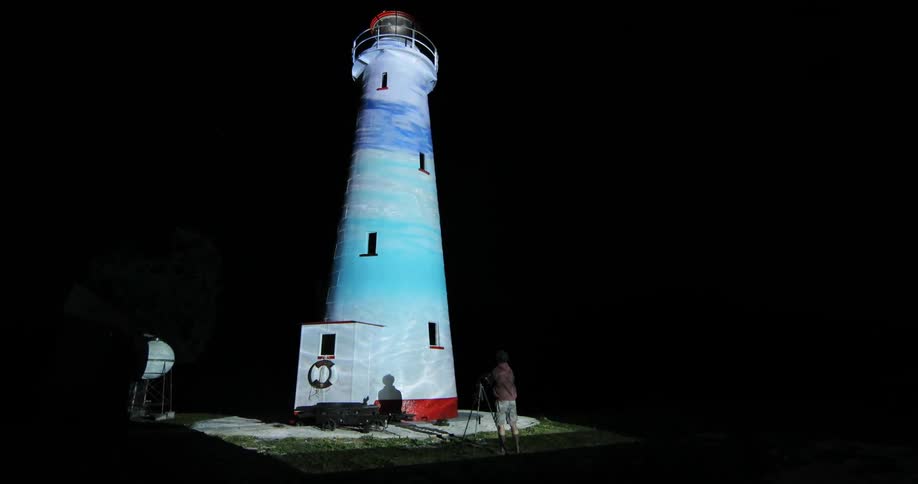 Photographer On Beach By Lighthouse