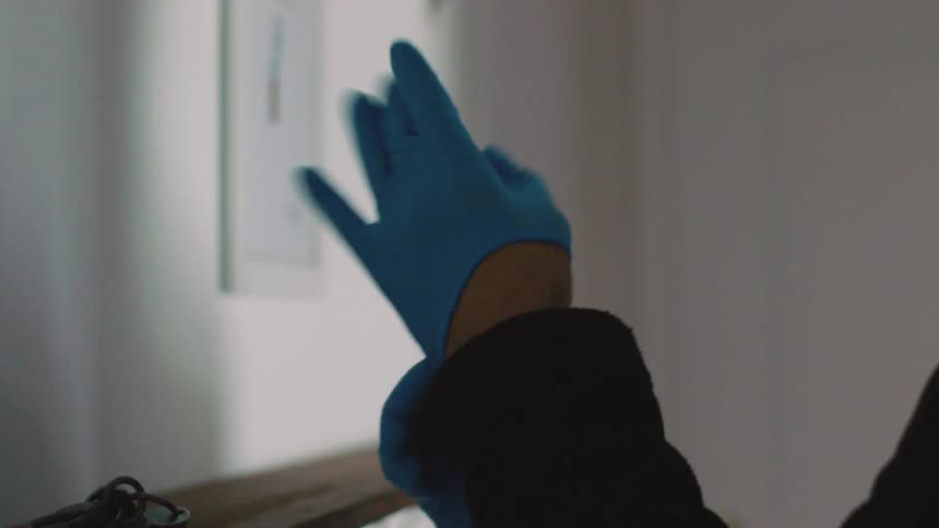 A person puts on medical gloves