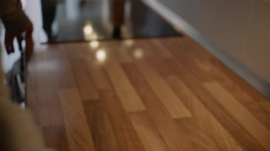 Man wipes the kitchen countertop in the kitchen