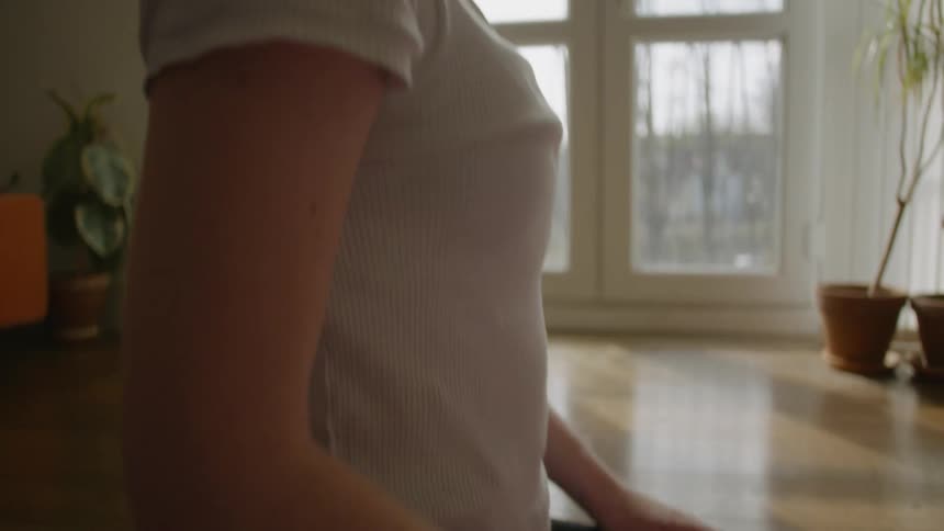 A woman does yoga in a living room