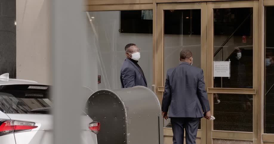 Two men wearing face masks try to open business door and find it is locked