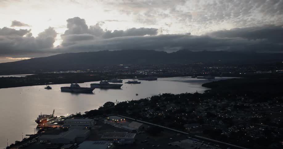 Boats sit in bay near seaside city at dusk