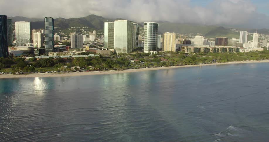 Aerial view of the city with tall buildings next to the ocean during daylight
