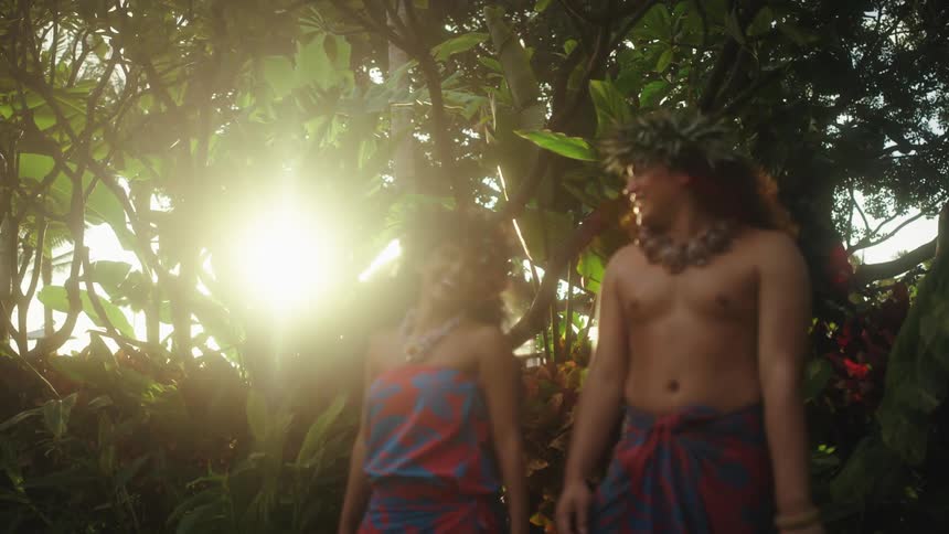 A man and woman laugh and prepare to perform