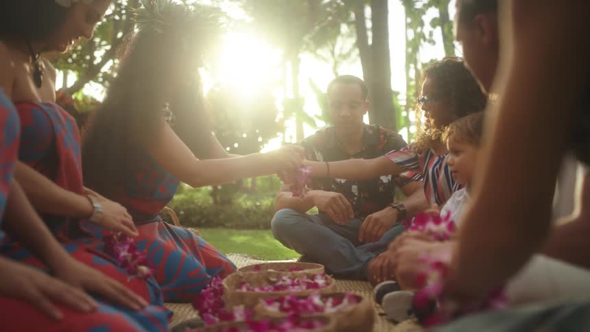 Woman tie flowers on a families wrists