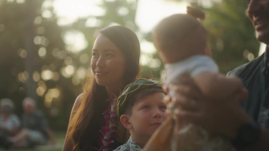 Parents and children wearing leis and smiling