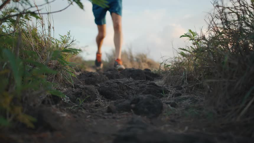 Man runs in the field during daylight