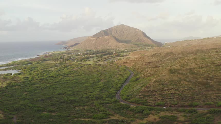 The shore is lined with grass and hills