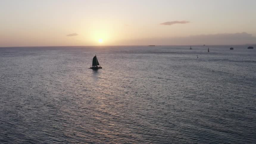 Sailboat on ocean at sunset