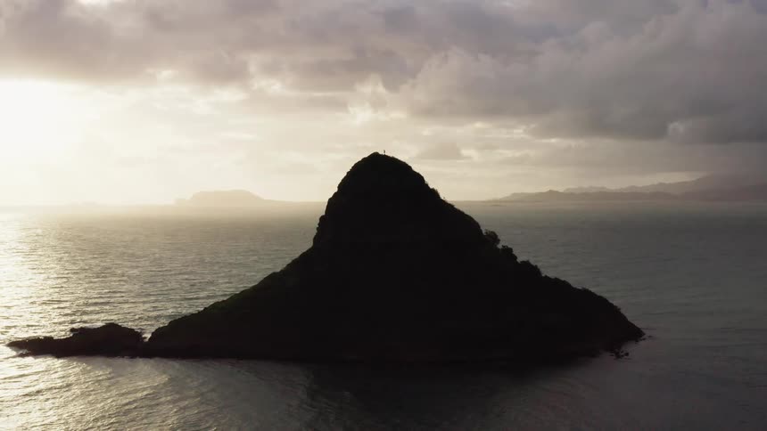 Island in the sea at sunset