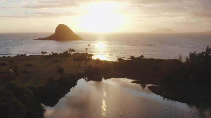 The sun is setting above the ocean