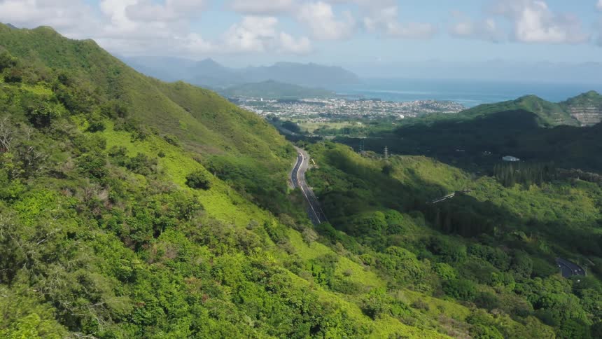 Aerial view of small beach front town between the mountains