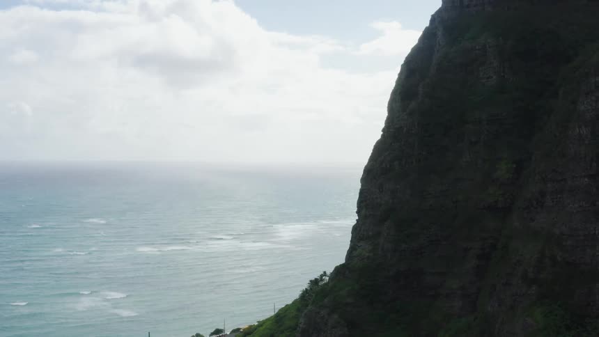 Cars drive along the coast