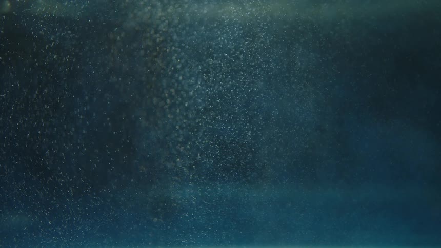 Air bubbles come to surface from under the water