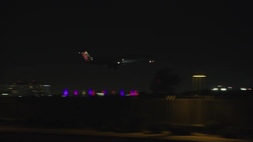 Airplane landing on runway at night
