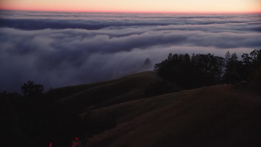 Time lapse of clouds moving across the hills