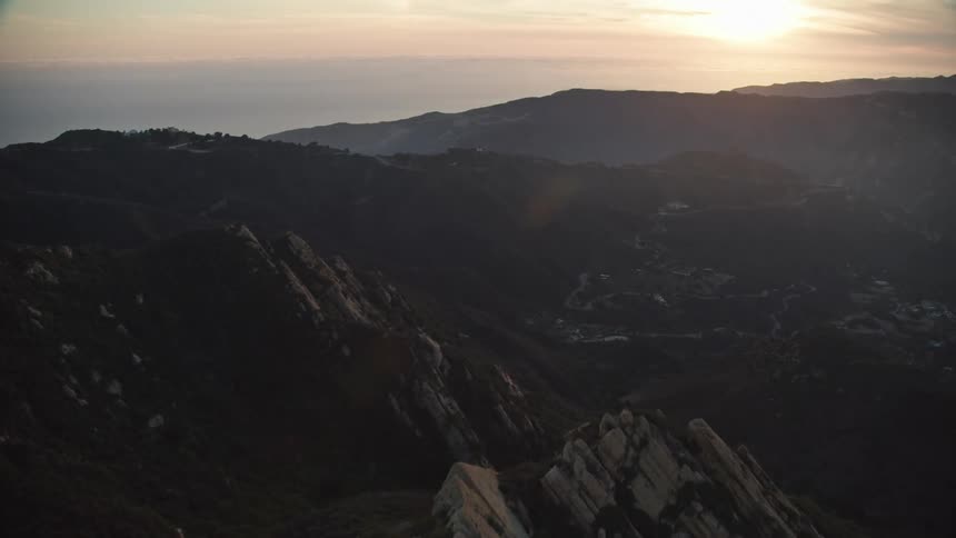 Aerial footage of rugged mountain range at dawn