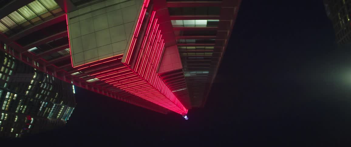 The buildings are tall and lined with neon lights