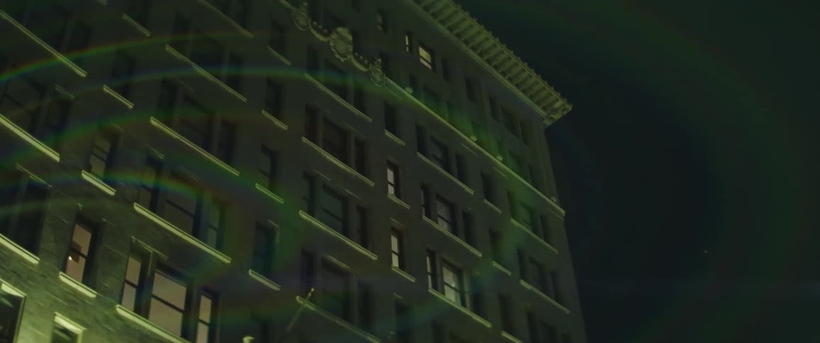 A building with windows is displayed during night