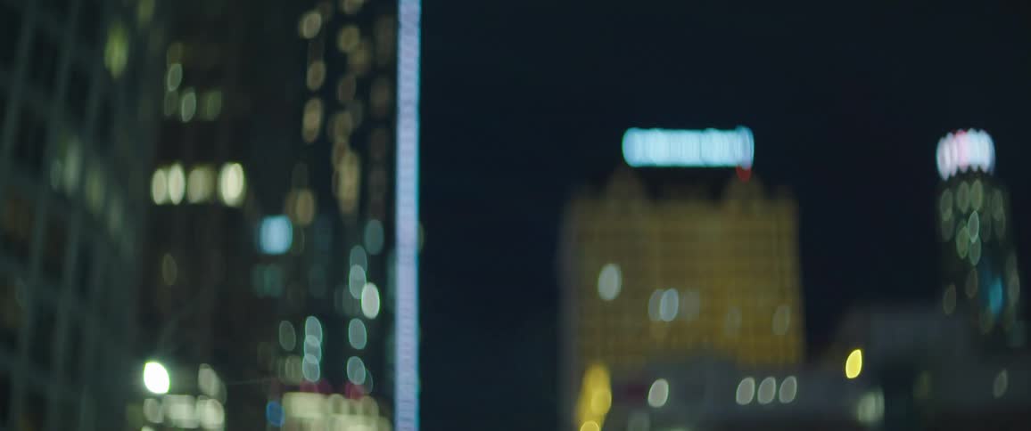 Out of focus footage of city downtown at nigth