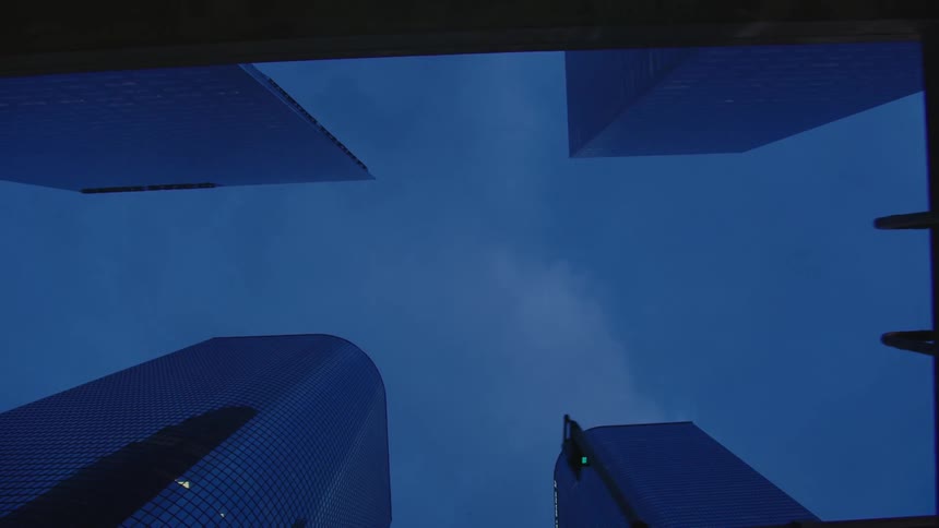 An urban street viewed from the ground towards the sky