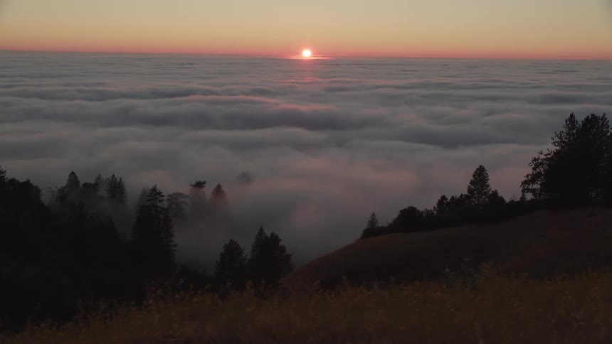 Sun sets over the clouds