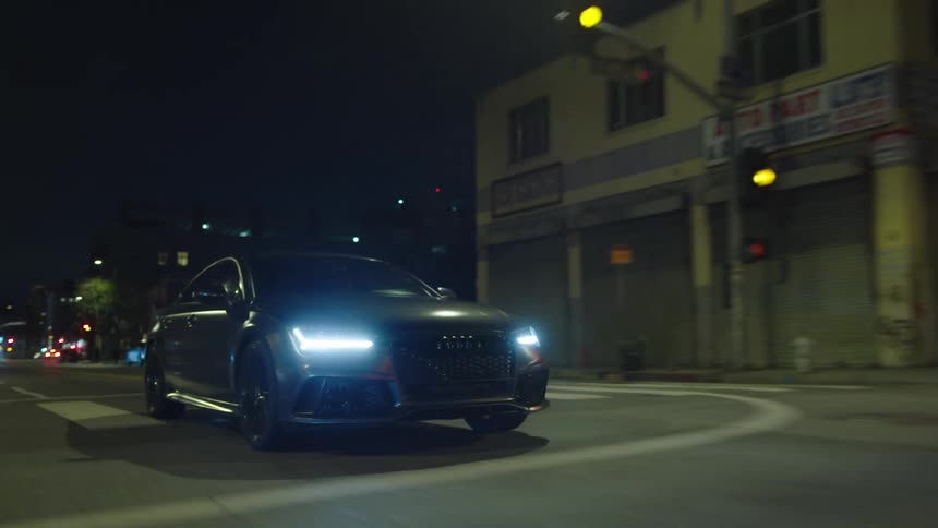 Car drives on the road in the city at night