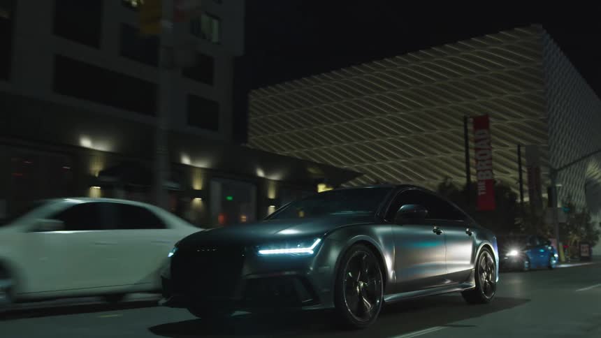 Car speeding on city street at night