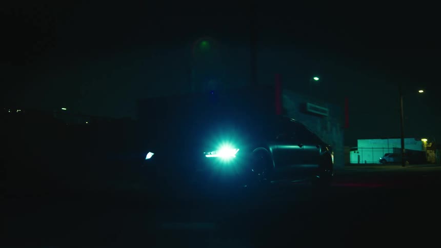 The vehicle lights up the road with its headlights