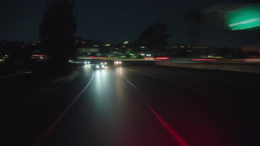 Sped up footage of cars traveling on freeway at night
