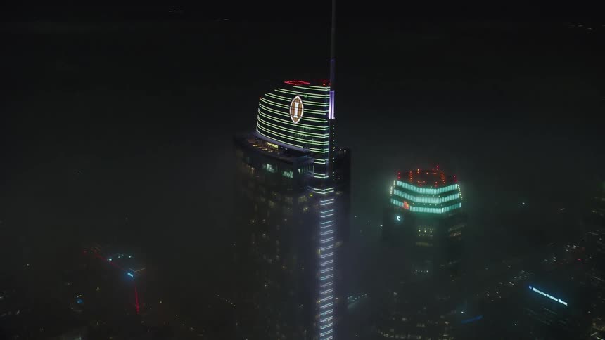 Aerial view skyscrapers covered in fog at night