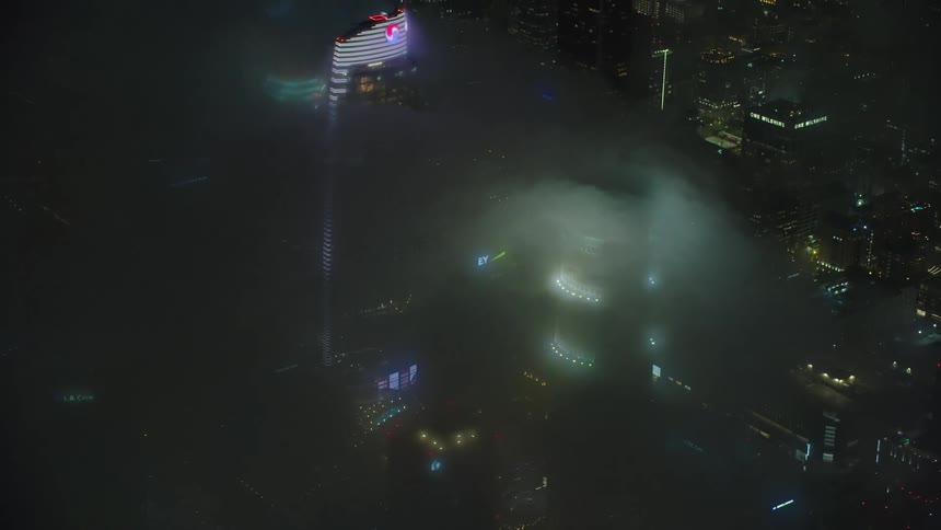 The clouds cover the buildings of the city