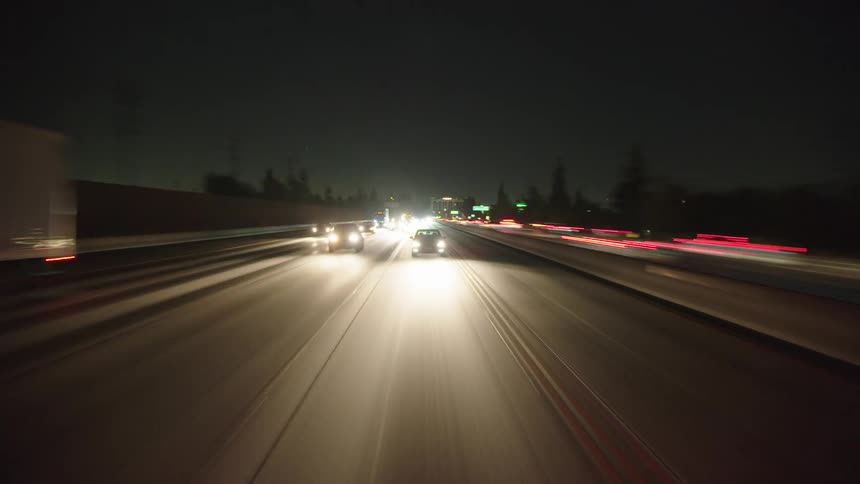 Time lapse of cars and trucks driving down a freeway