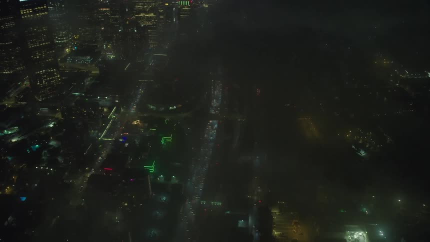 A busy city full of skyscrapers and buildings at night