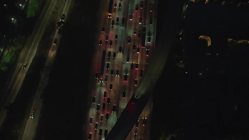 Birds eye view of cars driving down a busy freeway