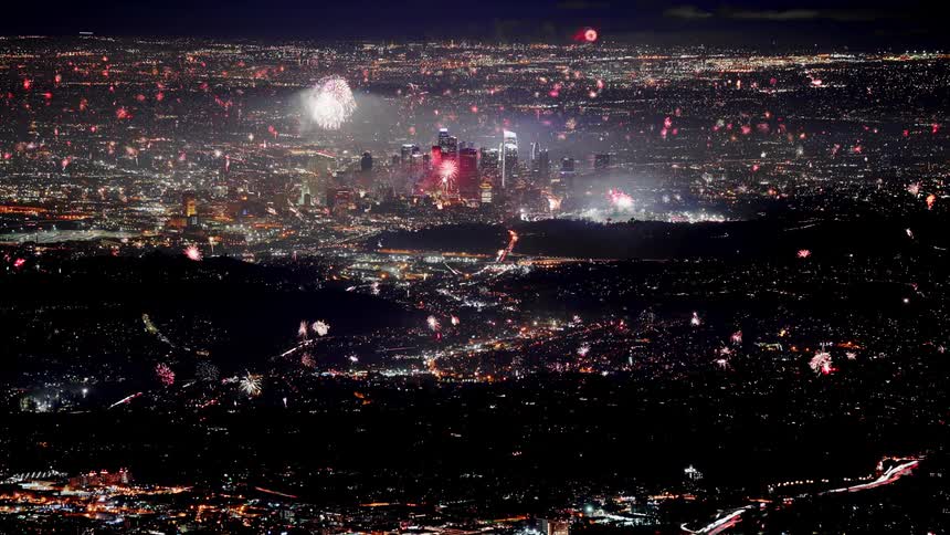 Timelapse of fireworks over city at night