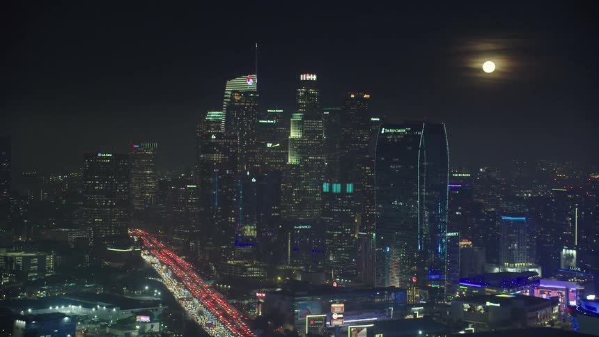The moon illuminates over downtown