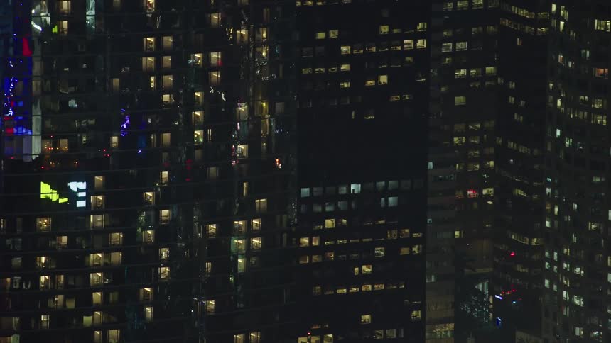 Light shines through windows in skyscrapers