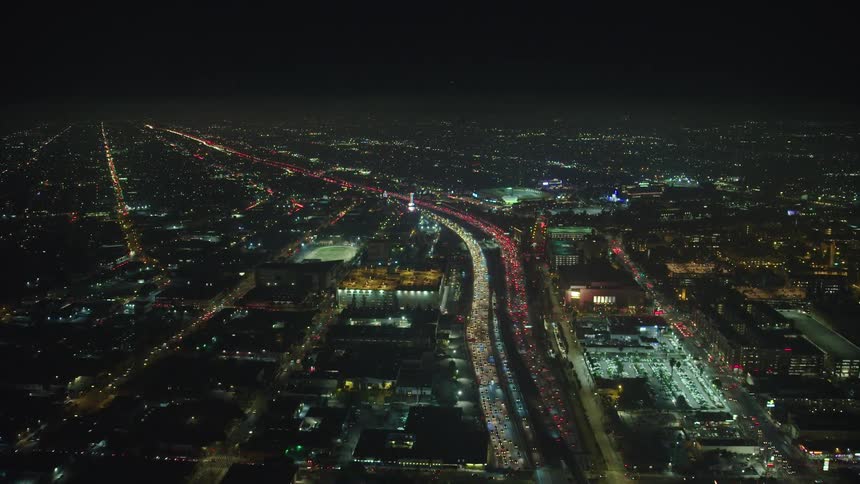 Aerial view of traffic jam and illuminated city at night