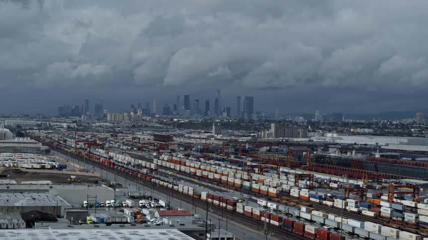 Clouds hang over a large busy city