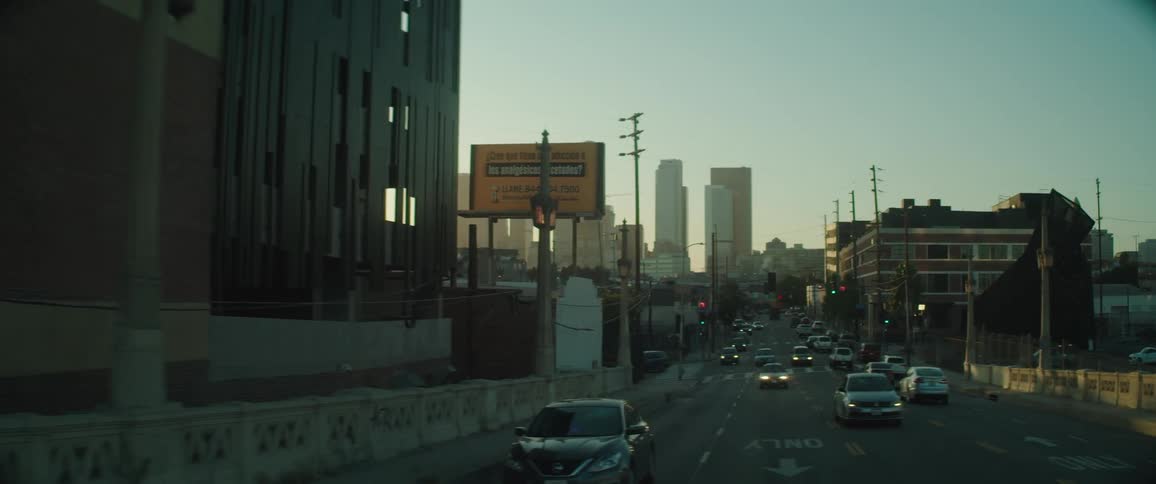Traffic on city street with skyline in background