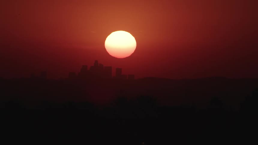 The sun goes down behind the city