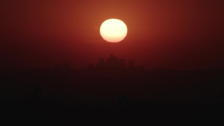 Red sky sunset over city skyline